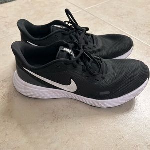 Black Nike Revolution running shoes